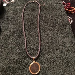Gold coin pendant on silver chord
