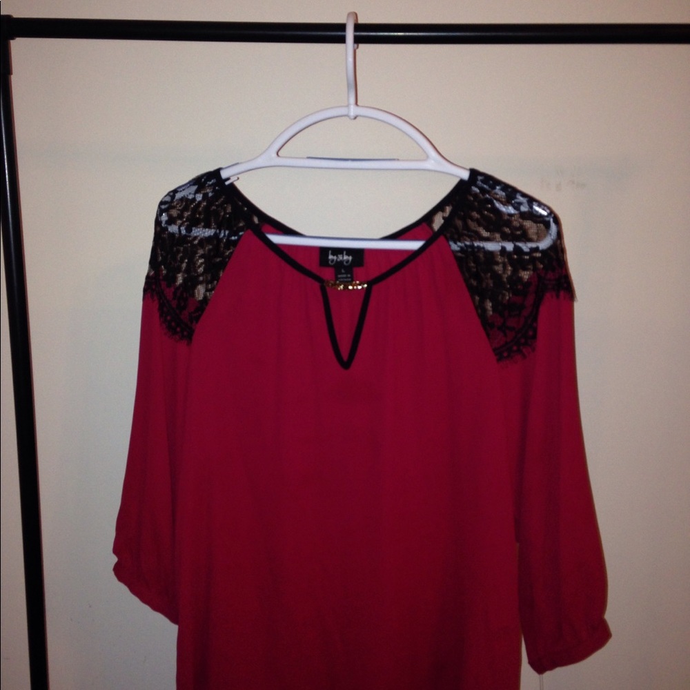 Wine colored sheer top with gold accent piece