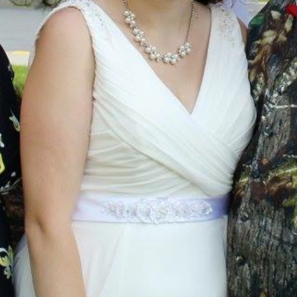 Wedding dress includes sash and veil