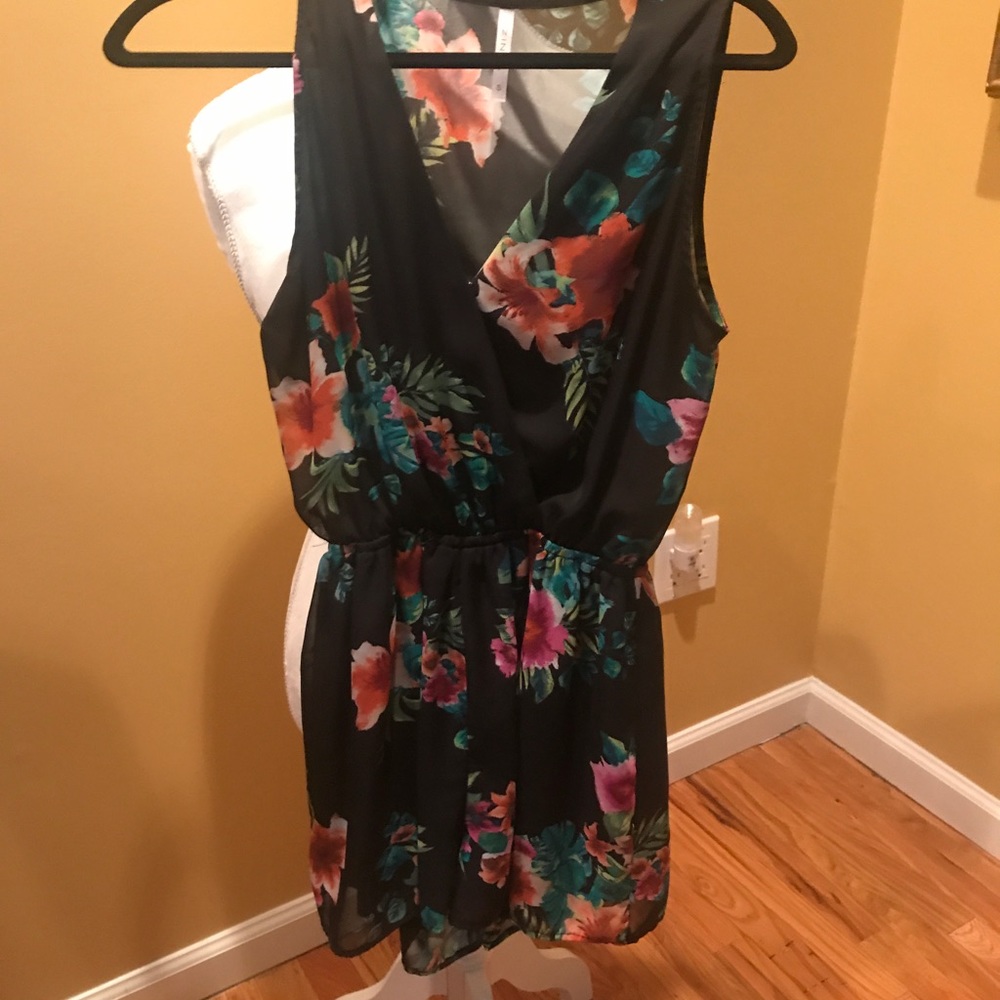 Black floral romper. Red and green flowers