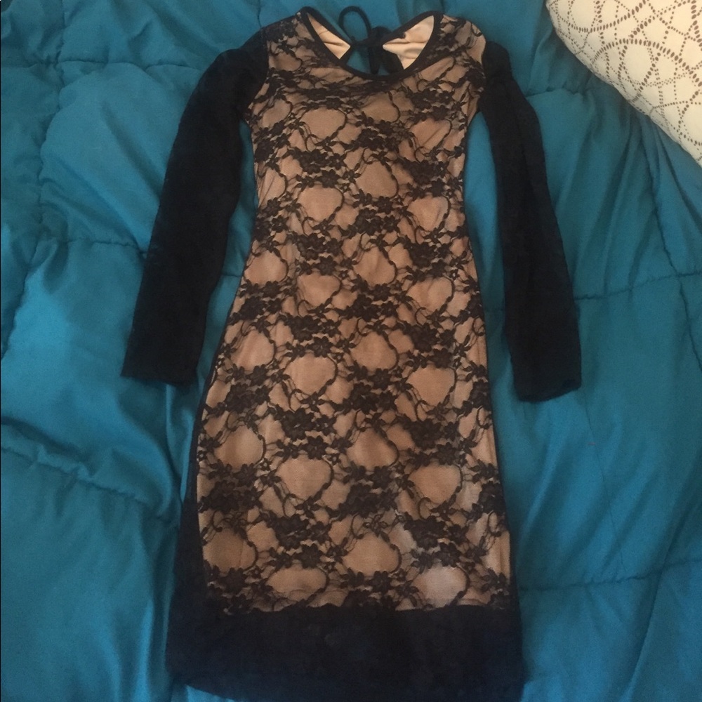 This is a black lace dress with a nude undertone.