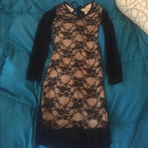 This is a black lace dress with a nude undertone.