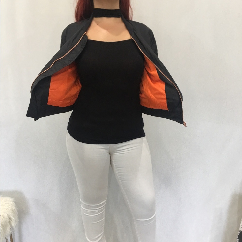 Padded black bomber jacket with orange lining