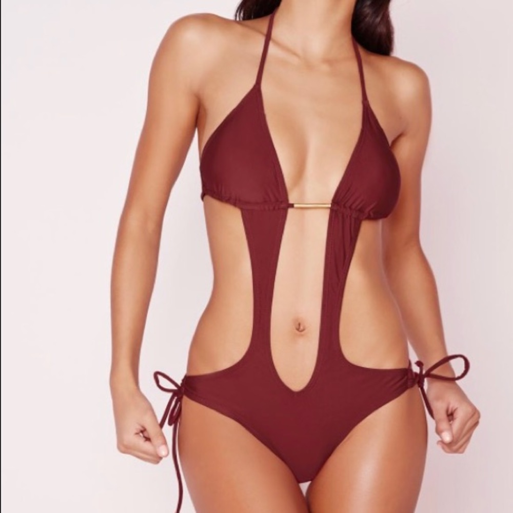 Cut away swimsuit with gold bar trim