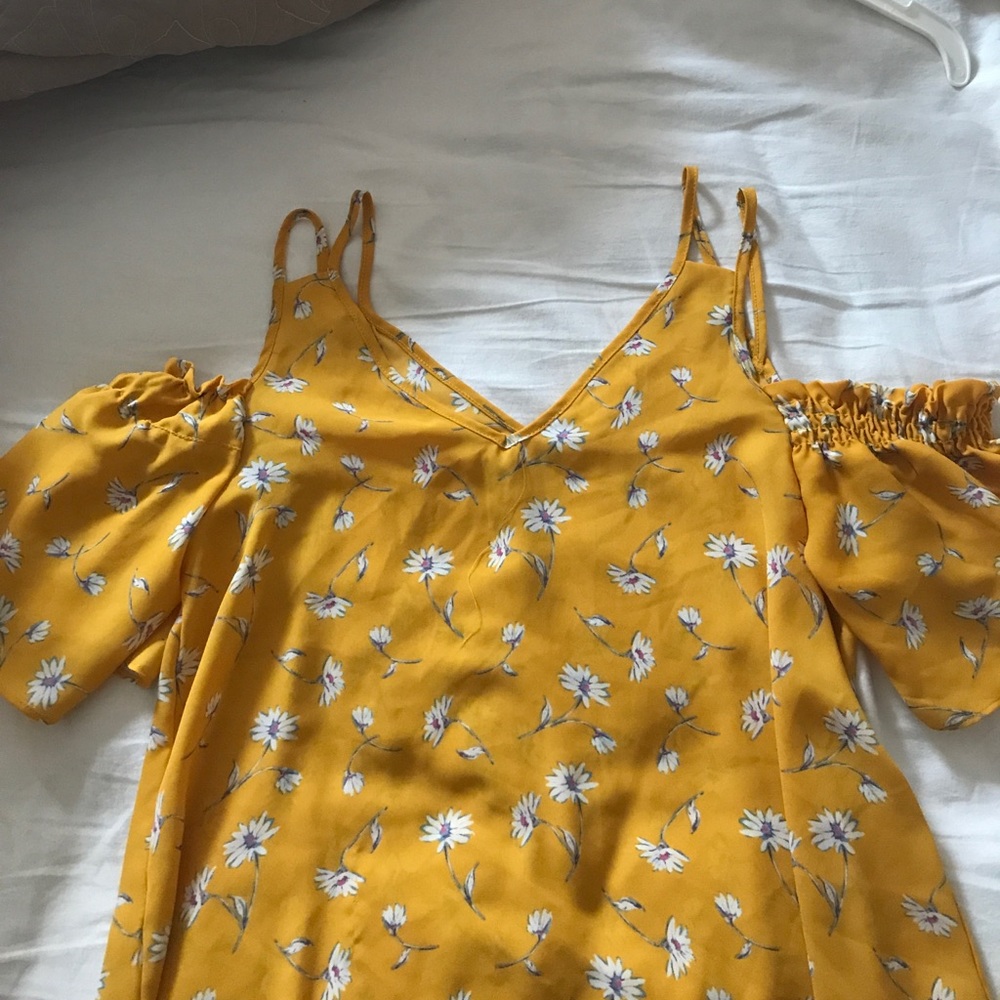 Strap tank top with off the shoulder sleeves.