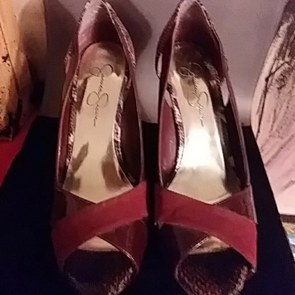 Burgundy heels with snake skin accents.