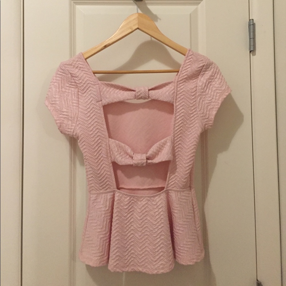 Pale pink peplum with open bow back