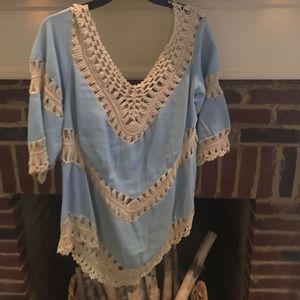 A linen top with crochet detail.