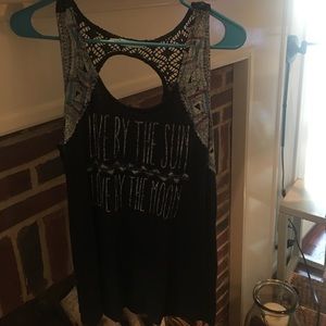 A graphic tank top with crochet detail
