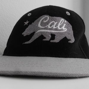 Black and gray cali hat with bear.