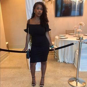 Black off the shoulder dress.