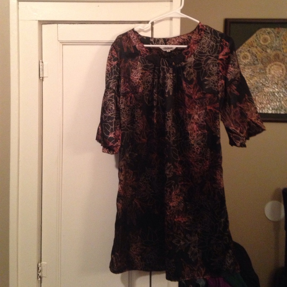 A black silky dress with golden and copper flowers