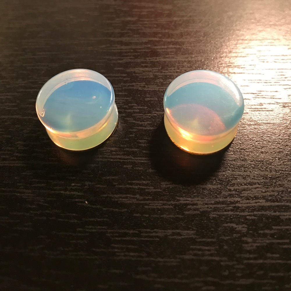 White glass plugs flared