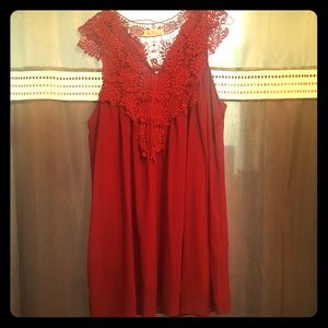 Wine color sleeveless dress.