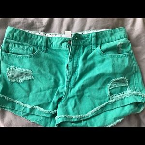 Green ripped high waisted shorts