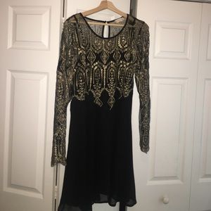 Sheer sleeves, gold embroidery.