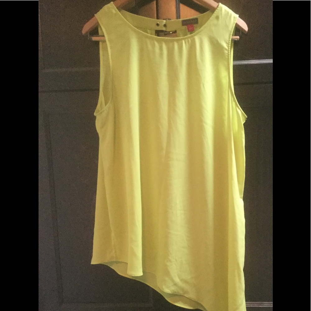 Bright green assymetrical sleeveless blouse.