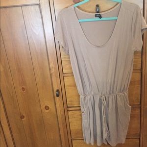 Adorable nude romper with pockets.