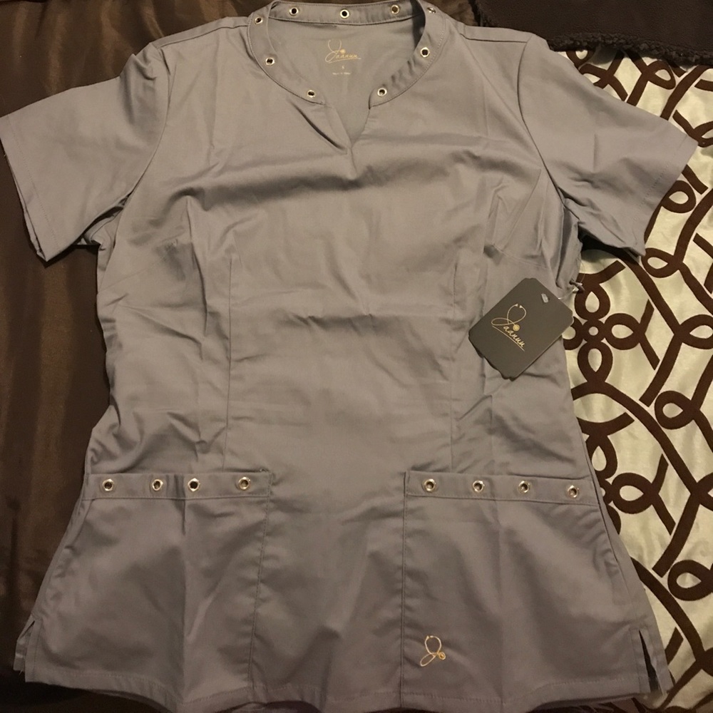 Jaanuu size Small scrub top. NEW. With tags