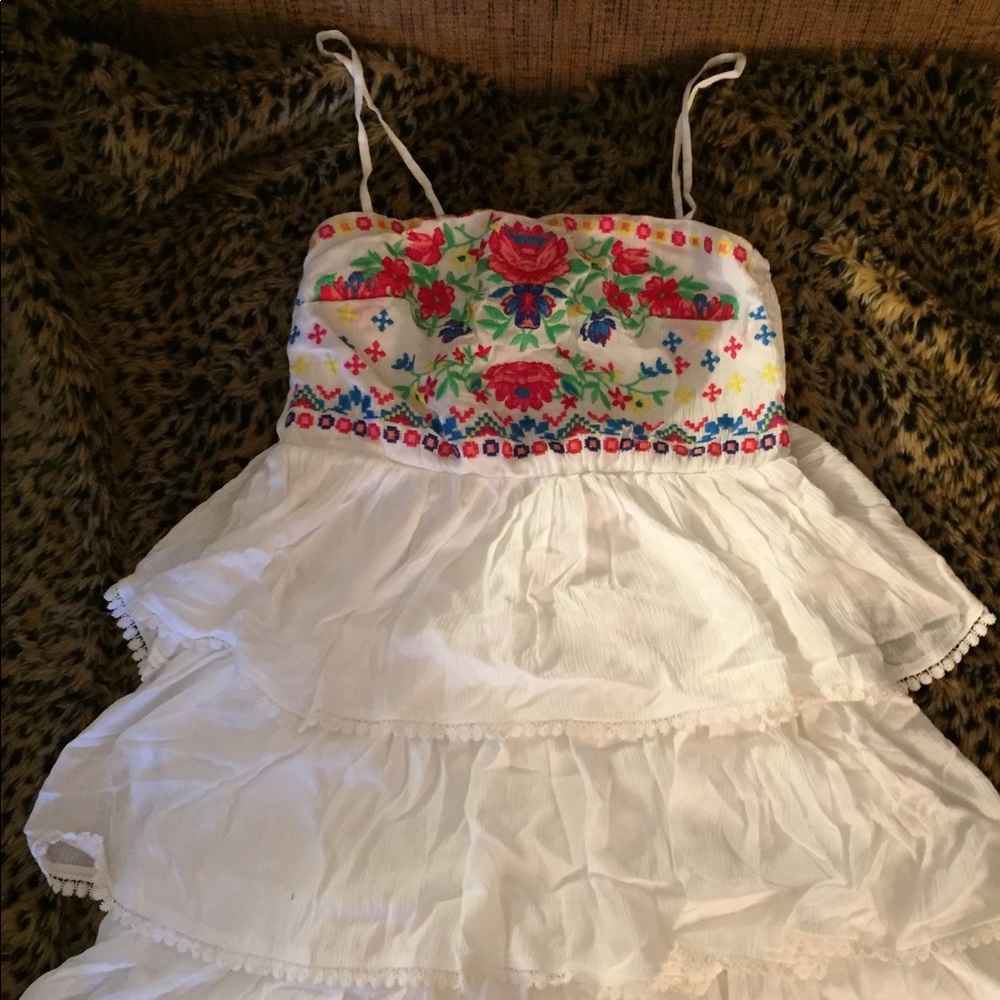 White ruffle dress with pink blue green embroidery