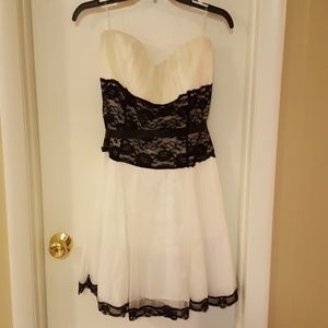 White dress with black lace waist and trim