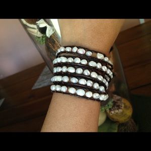Pearl bracelet on leather strand.