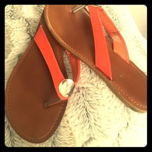Orange sandals with gold pendant