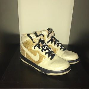 Gold and black Nikes