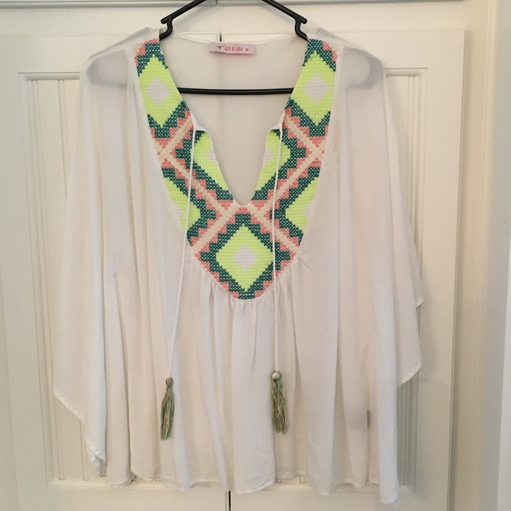 White flowy top with neon Aztec embroidery detail