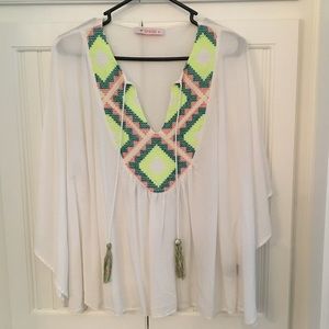 White flowy top with neon Aztec embroidery detail