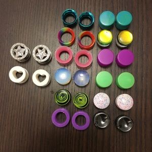 Assorted metal, acrylic, and stone plugs