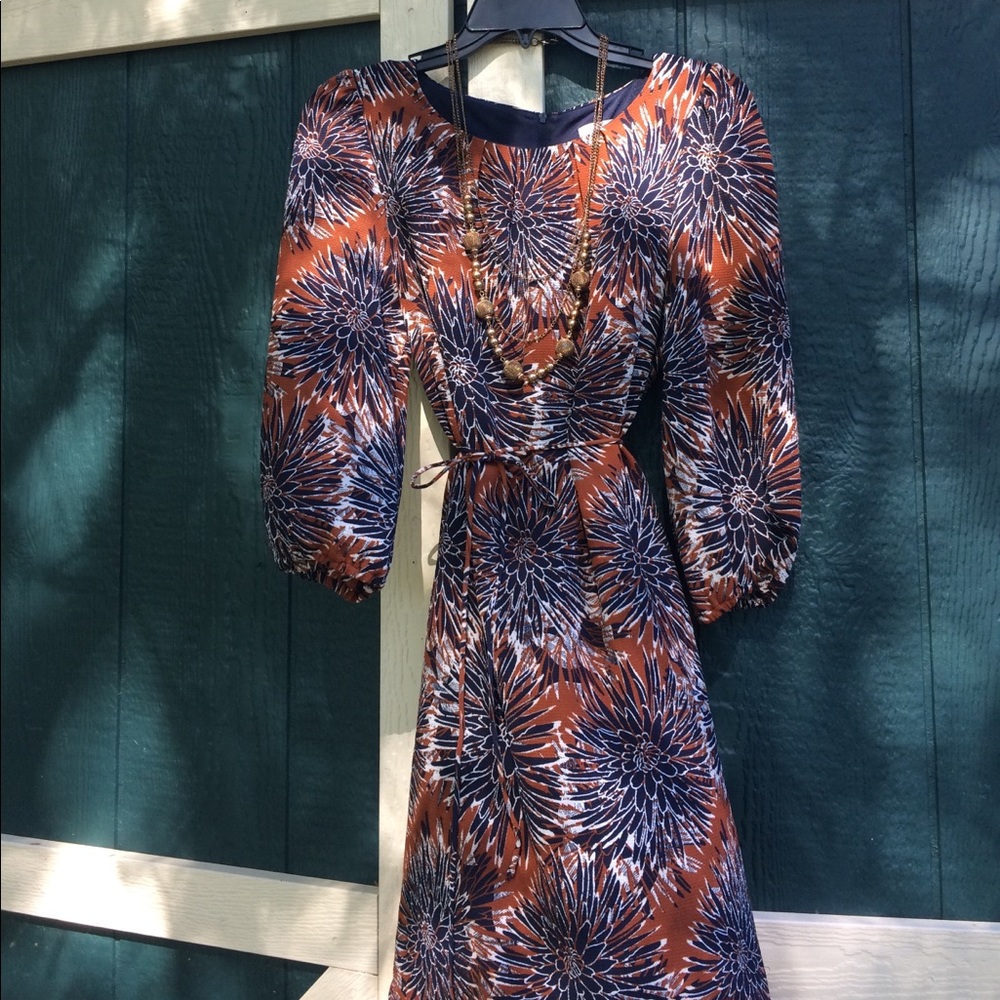 3/4 sleeve print dress w/ gold beaded necklace.