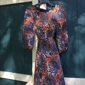 3/4 sleeve print dress w/ gold beaded necklace.