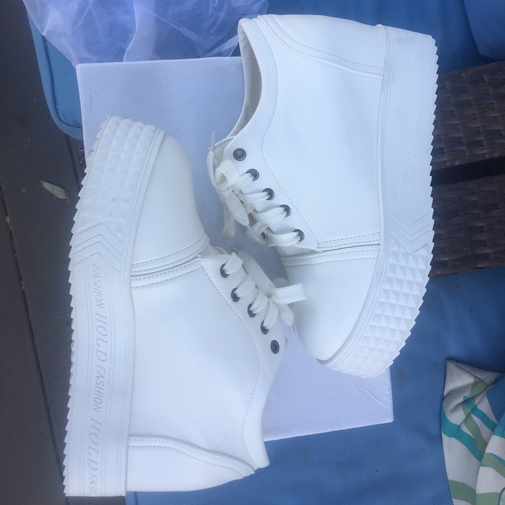White platform hidden wedge lace up sneakers.