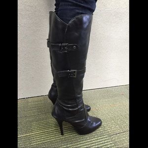 Knee high black boots with heel and buckle detail
