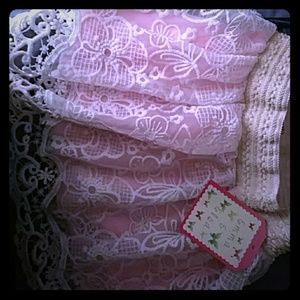 A white and pink floral lace skirt
