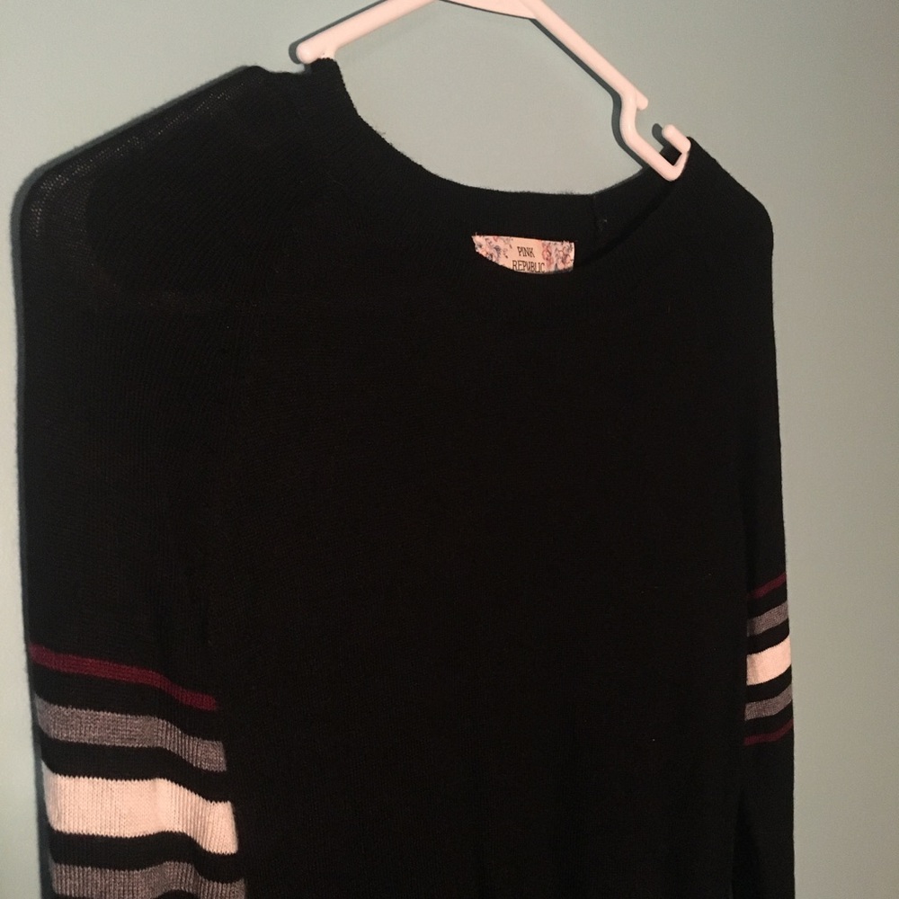Black sweater- purple and white stripes on sleeves