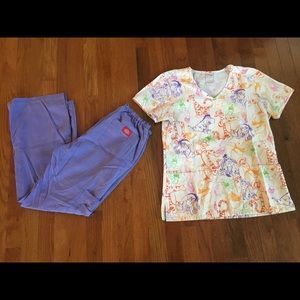Winnie the Pooh themed scrub top and purple pants.