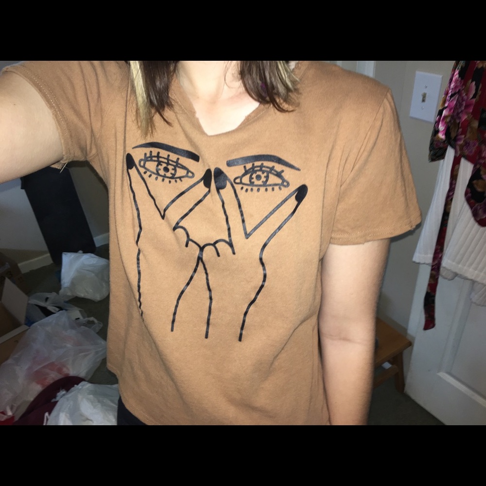 Light brown peace sign and eyes tee