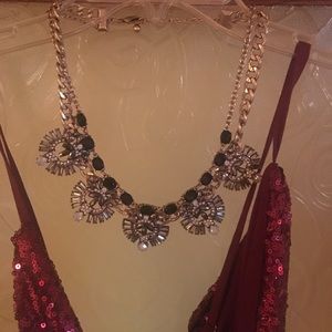 A silver and black jeweled necklace.