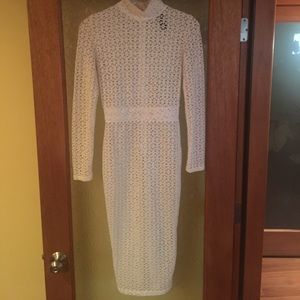 An all white knee length dress.