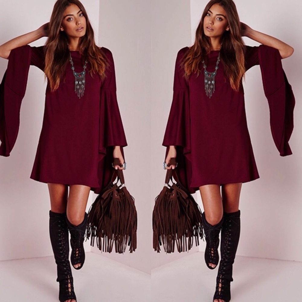 Mini red dress with long flair sleeves.