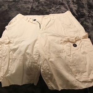 All white cargo shorts with black buttons
