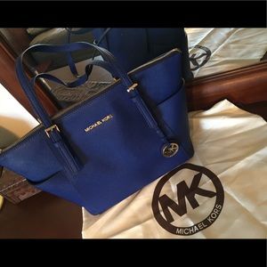 Blue Michael Kors Jet Set tote.