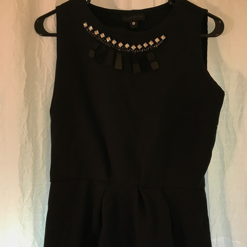 Black blouse with attached necklace piece.