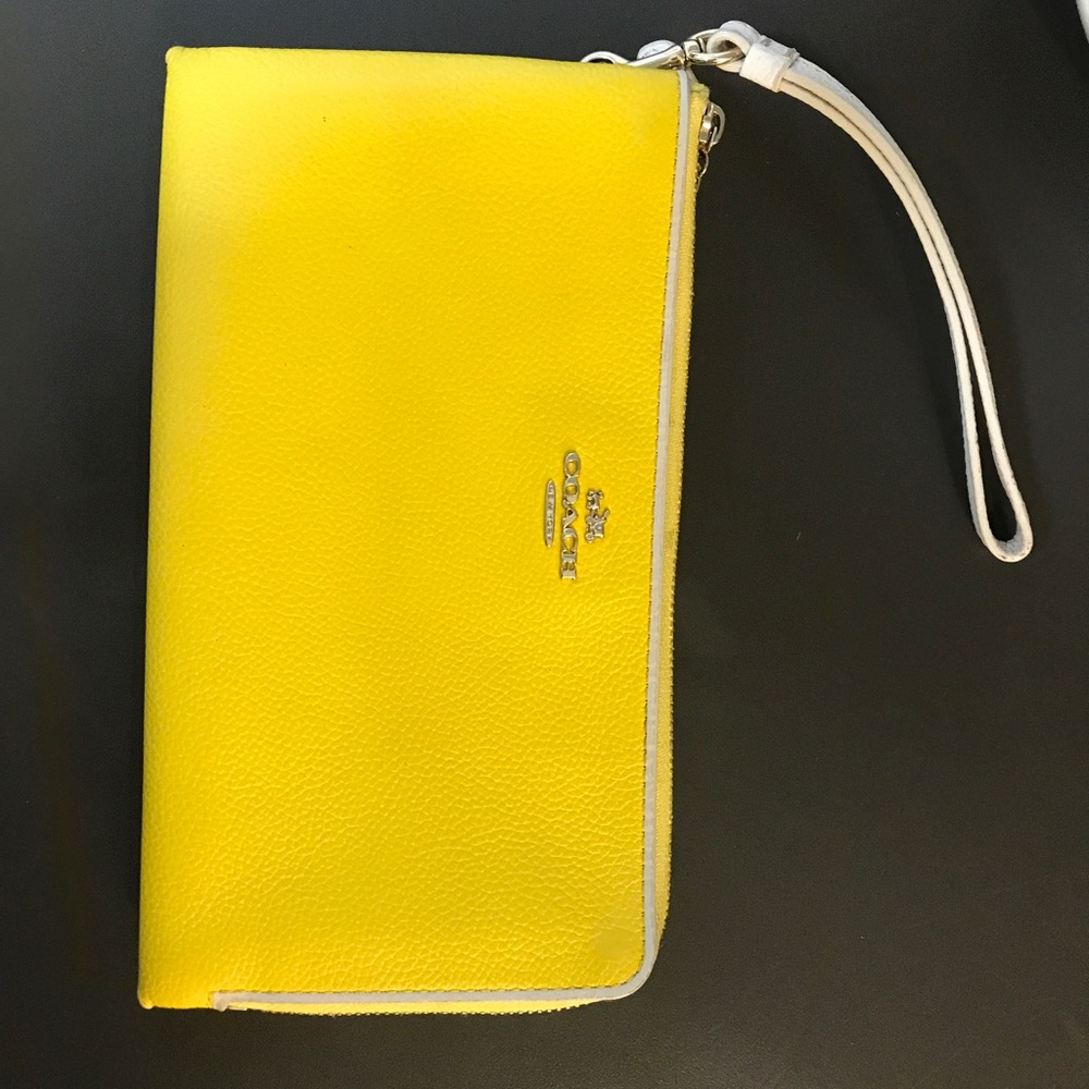 Bright yellow used coach wristlet / wallet