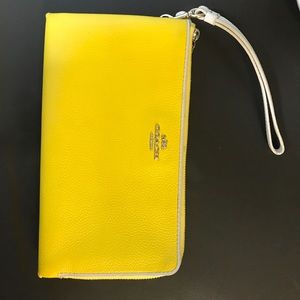 Bright yellow used coach wristlet / wallet