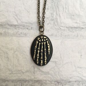 Skeleton hand cameo necklace