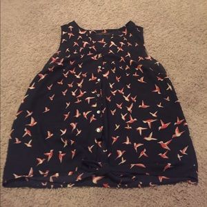 Sleeveless, button up top.