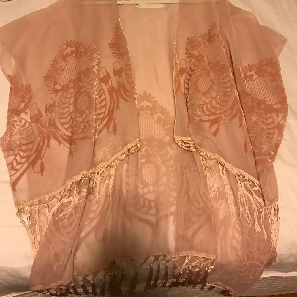 Blush colored poncho with fringe